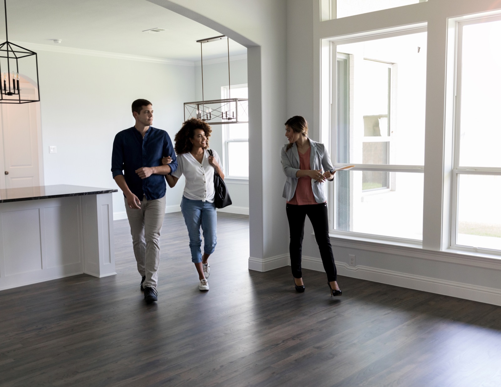 Real-estate agents walking through a clean, staged home